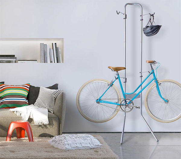 delta michelangelo stand holding one bike and helmet in a studio apartment