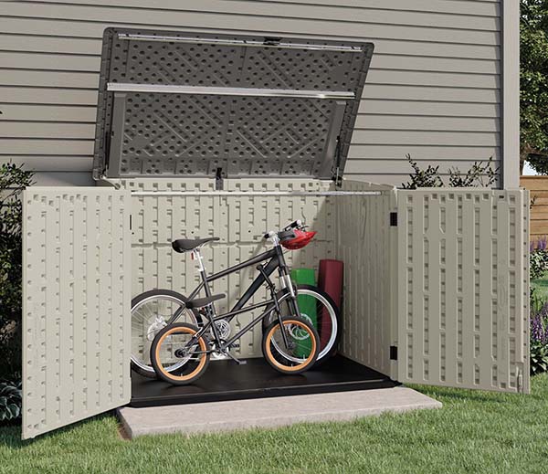 suncast stow-away storing bikes in the backyard