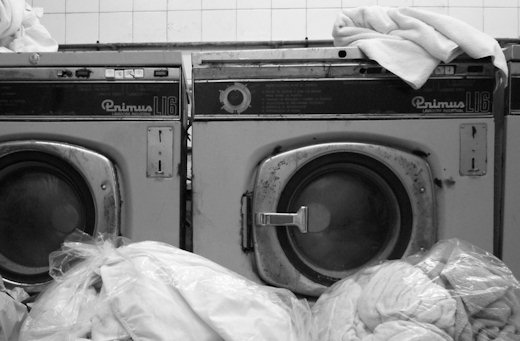 dirty laundry stacked at machines